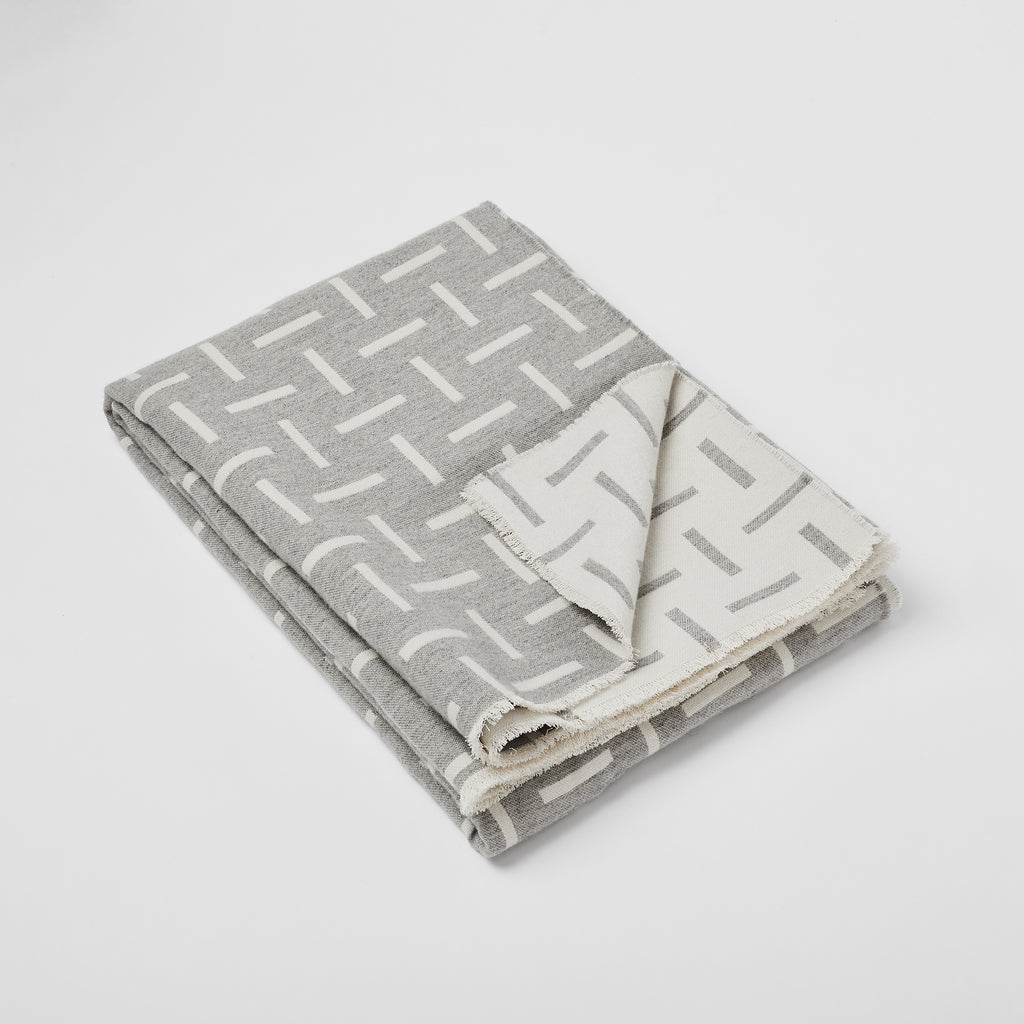Grey merino wool blanket. Contemporary, geometric design. Woven in England.