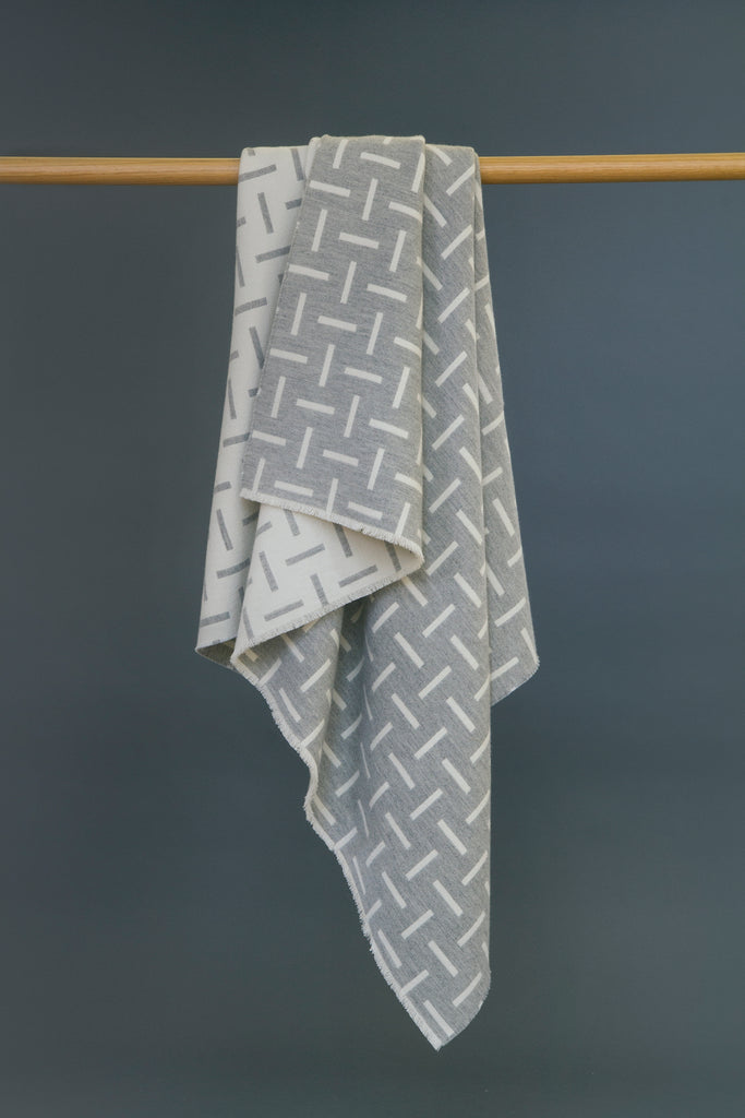 Grey, merino wool blanket. Contemporary, geometric design. Woven in England.