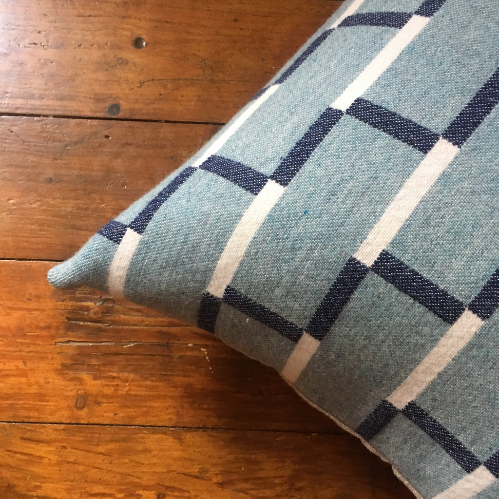 Contemporary merino wool cushion, teal and navy blue. Woven in England.