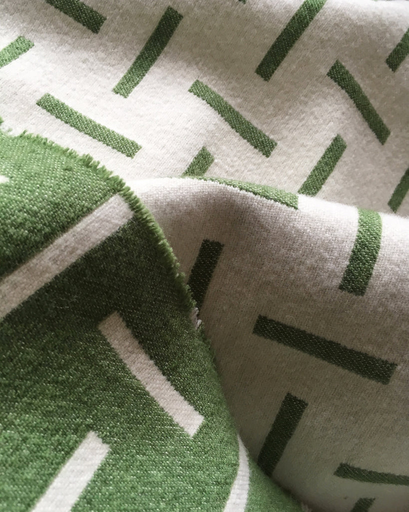 Green merino wool blanket. Contemporary, geometric design. Woven in England.