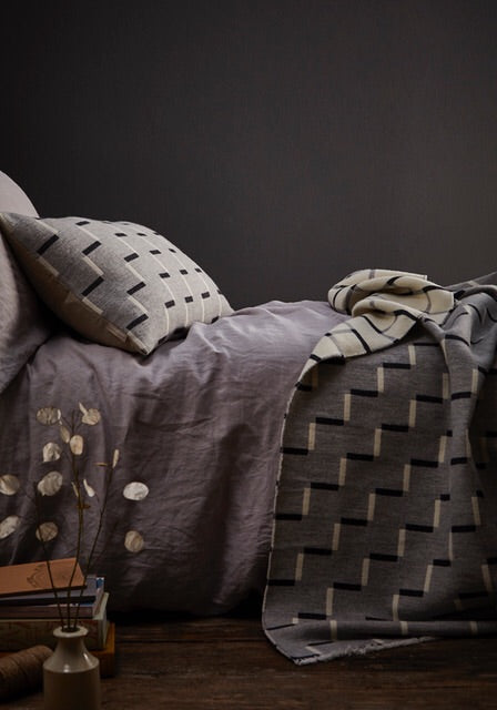 Contemporary, grey, merino wool blanket. Geometric, monochrome design. Woven in England.